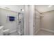 Bathroom featuring a glass door shower, towel rack, and wire rack for storage at 5760 Midnight Pass Rd # 307D, Sarasota, FL 34242