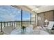 Enjoy the ocean views from this condo's screened lanai with seating and ceiling fan at 5770 Midnight Pass Rd # 705C, Sarasota, FL 34242