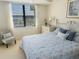 Bright bedroom with a water view and comfortable chair at 5770 Midnight Pass Rd # 705C, Sarasota, FL 34242