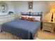 Bedroom with comfy bed, dresser, and stylish mirror at 5770 Midnight Pass Rd # 705C, Sarasota, FL 34242