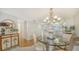 Elegant dining room with chandelier lighting and views into the modern kitchen at 5770 Midnight Pass Rd # 705C, Sarasota, FL 34242