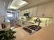 Bright kitchen featuring white cabinets, stainless steel appliances, and a breakfast nook area at 5770 Midnight Pass Rd # 705C, Sarasota, FL 34242