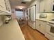 Cozy eat-in kitchen with stainless steel refrigerator, and hardwood flooring at 5770 Midnight Pass Rd # 705C, Sarasota, FL 34242
