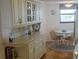 Eat-in kitchen offering beautiful display cabinets, hardwood floors and a table for four at 5770 Midnight Pass Rd # 705C, Sarasota, FL 34242