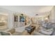 Inviting living room with comfortable seating, TV, and adjacent dining area at 5770 Midnight Pass Rd # 705C, Sarasota, FL 34242