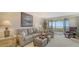 Comfortable living room with plush seating and access to the lanai with ocean view at 5770 Midnight Pass Rd # 705C, Sarasota, FL 34242
