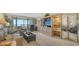 Spacious living room featuring plush seating, entertainment center, and balcony access at 5770 Midnight Pass Rd # 705C, Sarasota, FL 34242