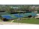 Aerial view of tennis courts with blue and green surfaces at 5770 Midnight Pass Rd # 705C, Sarasota, FL 34242