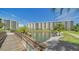 Exterior view of community buildings over the water, with a wooden bridge in the foreground at 5770 Midnight Pass Rd # 705C, Sarasota, FL 34242