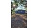 Large backyard with mature trees and patchy grass at 601 27Th W St, Bradenton, FL 34205