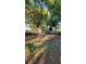 Large backyard with mature trees and patchy grass at 601 27Th W St, Bradenton, FL 34205