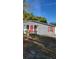 Gray house with red door and shutters, small front yard at 601 27Th W St, Bradenton, FL 34205