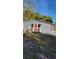 Cute bungalow with red door, landscaping, and a bird bath at 601 27Th W St, Bradenton, FL 34205