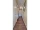 Long hallway with light walls and wood-look floors at 601 27Th W St, Bradenton, FL 34205