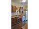 Kitchen with wood cabinets, double sink, and appliances at 601 27Th W St, Bradenton, FL 34205
