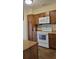 Kitchen with wood cabinets, stove, and microwave at 601 27Th W St, Bradenton, FL 34205
