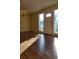 Living room with wood-look floors, large windows, and chandelier at 601 27Th W St, Bradenton, FL 34205