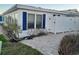 Exterior view of a building with blue shutters and a paved walkway at 957 Spanish N Dr, Longboat Key, FL 34228