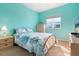 Bedroom with a metal bed frame and ocean-themed bedding at 1064 N Tamiami Trl # 1311, Sarasota, FL 34236