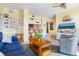 Living room with open kitchen, seating, and a large TV at 1064 N Tamiami Trl # 1311, Sarasota, FL 34236
