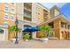 Exterior of a beautiful condo building with palm trees and a courtyard at 1064 N Tamiami Trl # 1311, Sarasota, FL 34236