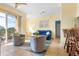 Bright living room with tiled floors, comfy seating, and access to a balcony at 1064 N Tamiami Trl # 1311, Sarasota, FL 34236