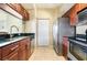 Modern kitchen with stainless steel appliances and dark wood cabinets at 1064 N Tamiami Trl # 1311, Sarasota, FL 34236