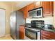 Stainless steel appliances and dark wood cabinets in this galley kitchen at 1064 N Tamiami Trl # 1311, Sarasota, FL 34236
