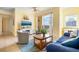 Living area featuring comfortable seating and a large TV at 1064 N Tamiami Trl # 1311, Sarasota, FL 34236