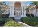 Elegant entryway with columns and double doors leading into the home at 1076 Mallard Marsh Dr, Osprey, FL 34229