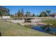 Wooden footbridge over a tranquil waterway, surrounded by lush landscaping at 13415 Swiftwater Way, Bradenton, FL 34211