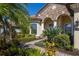 Front entry with lush landscaping and walkway at 13415 Swiftwater Way, Bradenton, FL 34211