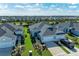 Aerial view of a new home community featuring multiple houses with gray roofs and landscaping at 14607 Barefoot Ln, Parrish, FL 34219