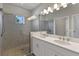 Bathroom with double vanity, walk-in shower, and pebble floor at 1904 Monte Carlo Dr, Sarasota, FL 34231