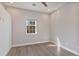 Bright bedroom with built-in wall unit and wood-look floors at 1904 Monte Carlo Dr, Sarasota, FL 34231