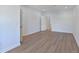 Spacious bedroom with wood-look floors and access to hallway at 1904 Monte Carlo Dr, Sarasota, FL 34231