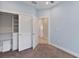 Bedroom with light blue walls, carpeted floor and a closet at 1904 Monte Carlo Dr, Sarasota, FL 34231