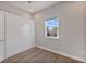 Bedroom with built-in wall unit and wood-look floors at 1904 Monte Carlo Dr, Sarasota, FL 34231