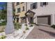 Townhome entry with attached garage, paver driveway, and tropical landscaping at 1904 Monte Carlo Dr, Sarasota, FL 34231