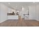 Open concept living room and kitchen with hardwood floors and island at 1904 Monte Carlo Dr, Sarasota, FL 34231