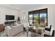 Open concept living and dining area with access to a balcony at 1904 Monte Carlo Dr, Sarasota, FL 34231