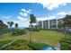 Landscaped grounds with waterfront view and building exterior at 2120 Harbourside Dr # 617, Longboat Key, FL 34228