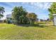 Landscaped backyard featuring tropical plants and a large lawn at 312 San Marie Dr, Punta Gorda, FL 33950