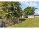 Large backyard with sheds and lush tropical landscaping at 312 San Marie Dr, Punta Gorda, FL 33950