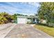 Light teal home with a white garage door and landscaped yard at 312 San Marie Dr, Punta Gorda, FL 33950