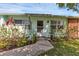Front view of a teal house with lush landscaping and walkway at 312 San Marie Dr, Punta Gorda, FL 33950