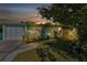 Charming teal home with a white garage door and well-maintained landscaping at 312 San Marie Dr, Punta Gorda, FL 33950