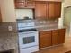 Efficient kitchen showcasing ample cabinetry and a white stove at 312 San Marie Dr, Punta Gorda, FL 33950