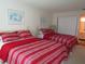 Bedroom with two queen beds and red striped bedding at 4546 Longwater # 44, Sarasota, FL 34235