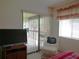 Bedroom with patio access and wicker seating area at 4546 Longwater # 44, Sarasota, FL 34235